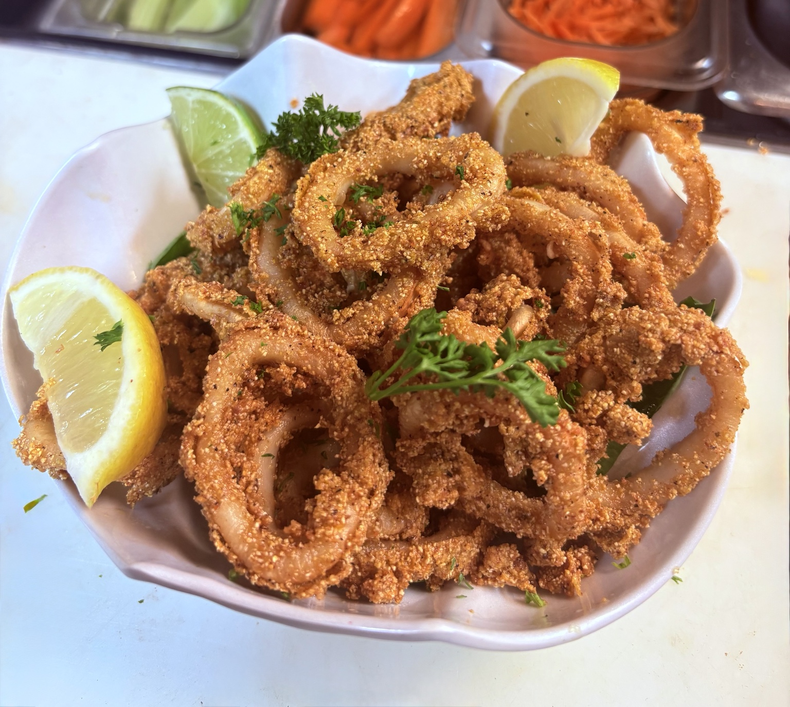 Crispy fried calamari with lemon, lime and herbs