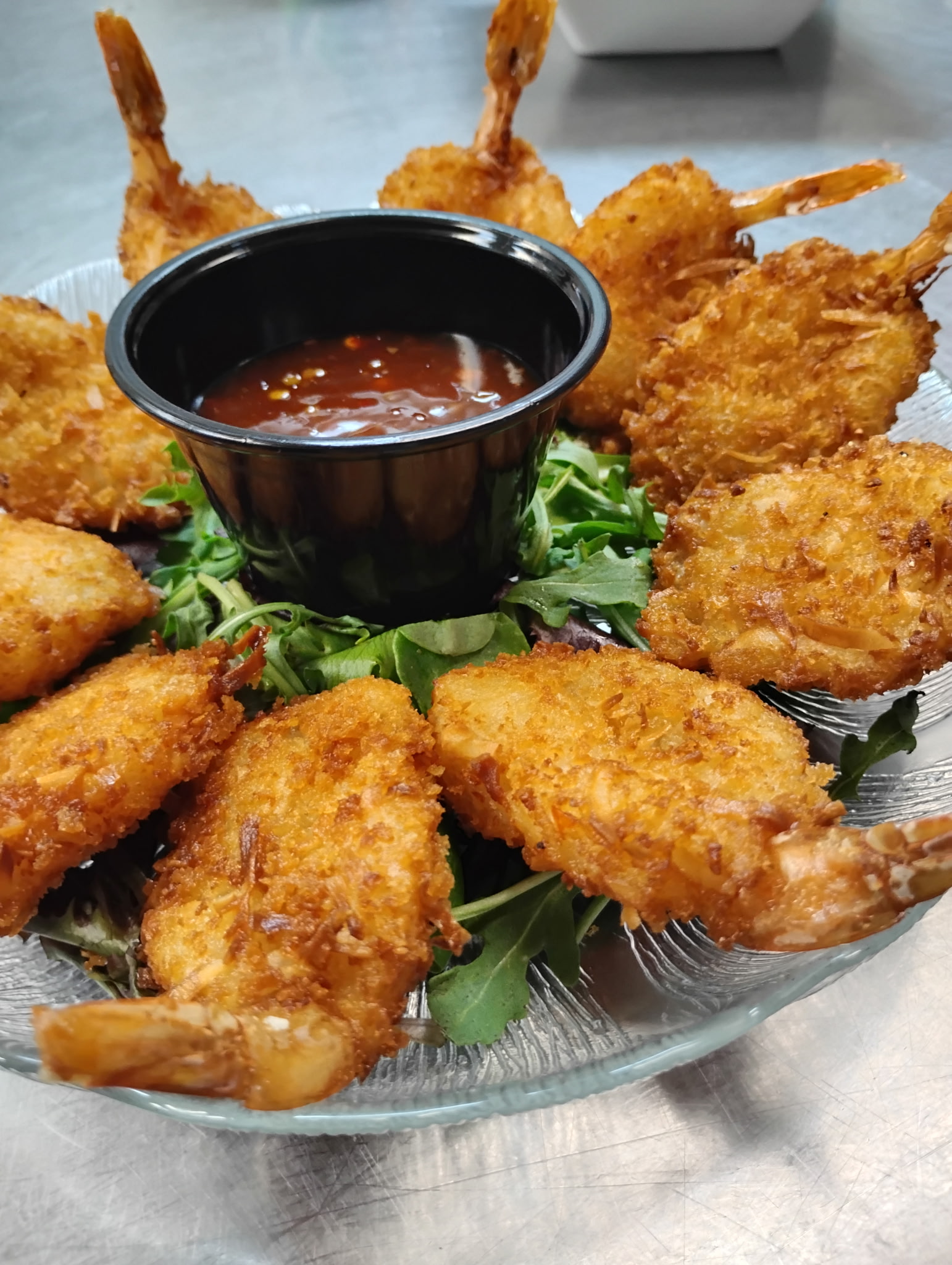 Golden crispy shrimp arranged around dipping sauce